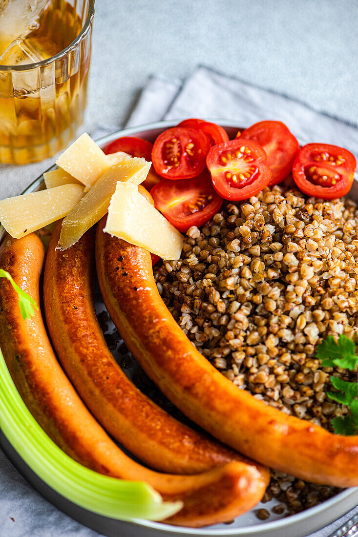 Healthy lunch bowl with buckwheat and sausages, served on the table