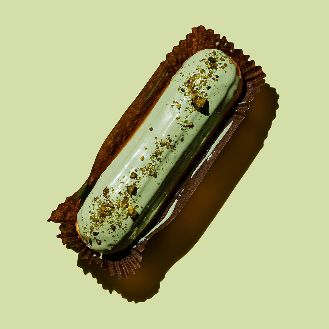 Pistachio eclair on a green background