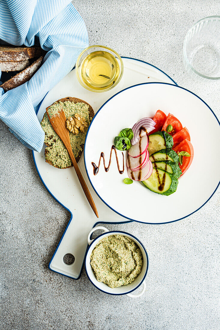 Healthy lunch from above with vegetable salad and toast with walnut paste