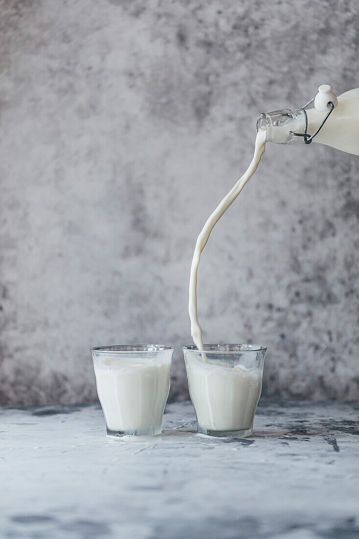 Plant-based milk is poured into a glass