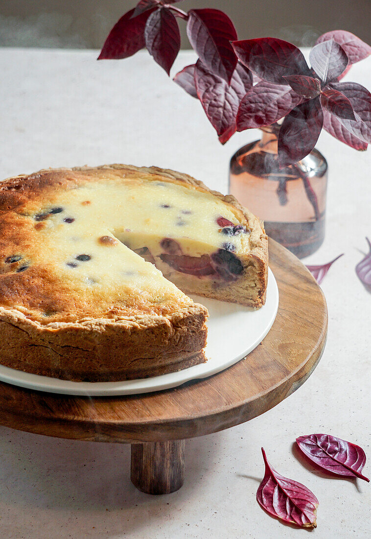 Plum cake in Asian minimalism, soft light, white linen tablecloth