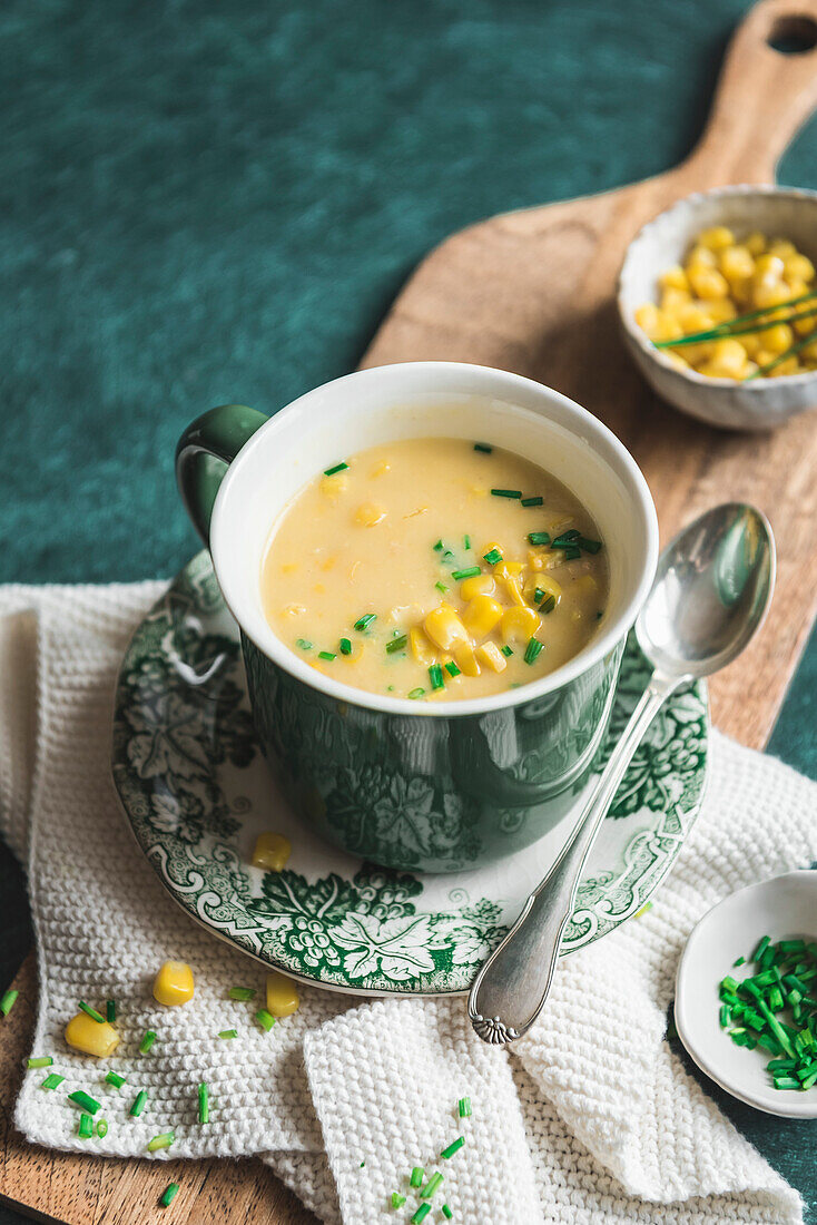 Corn Chowder served in a green mug with sweetcorn