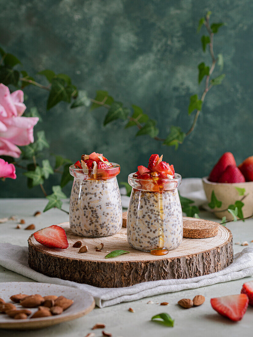 Chia and Oats pudding with almonds, strawberries and honey over a rustic base and a napkin