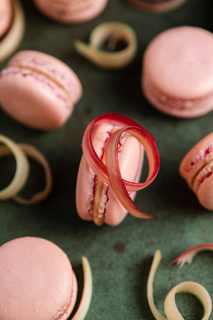 Rhubarb macarons on a green background