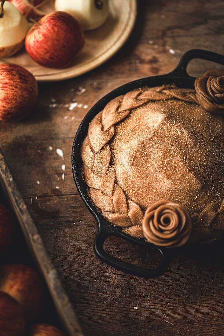 A pan-fried apple pie in a rustic kitchen