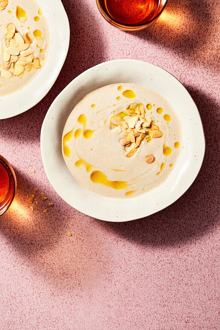 Chilled almond soup on a pink background
