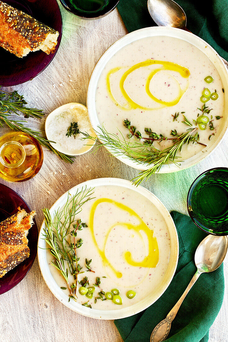 Purple potato and fennel bisque on a white table