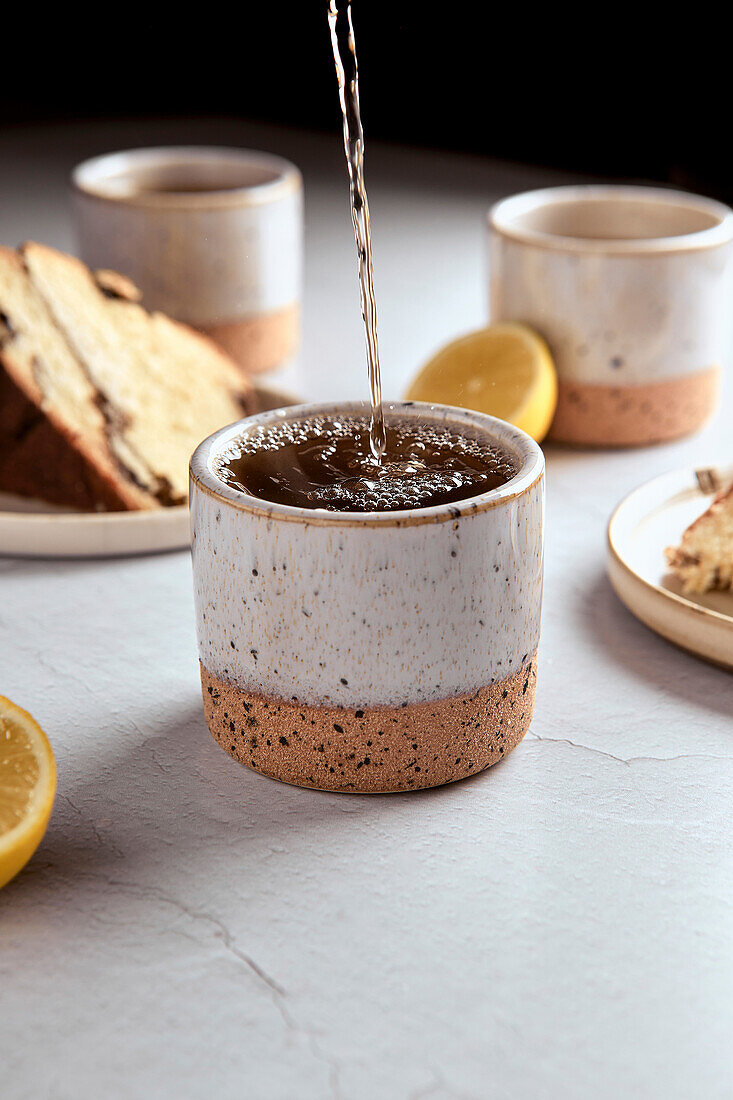 Black tea with lemon in small ceramic cups