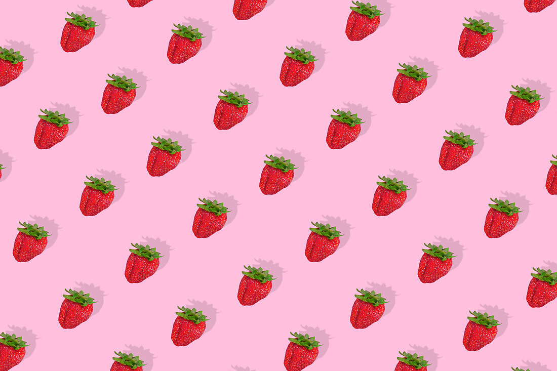 Modern retro colour theme with red strawberries on a pink background