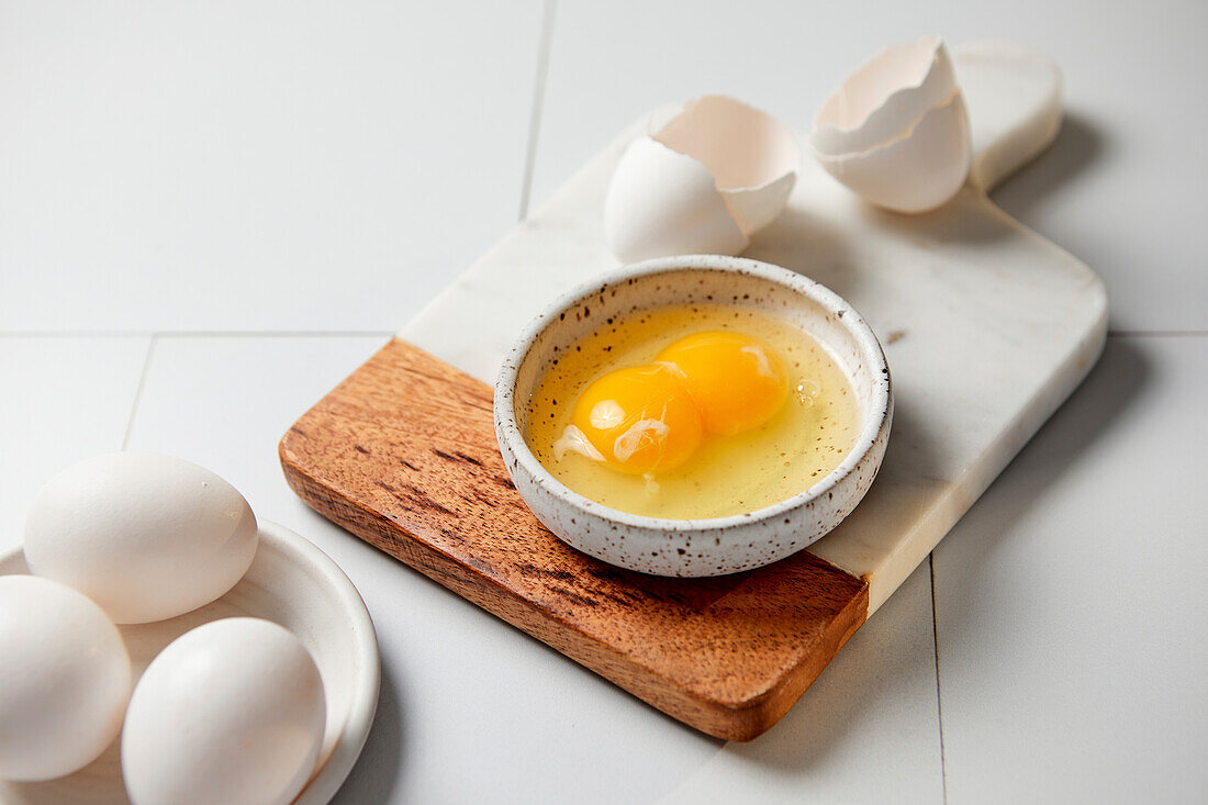 Egg with double yolk whipped in a small bowl