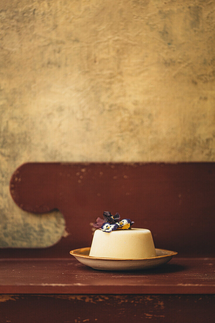 Panna cotta on a plate in a rustic kitchen