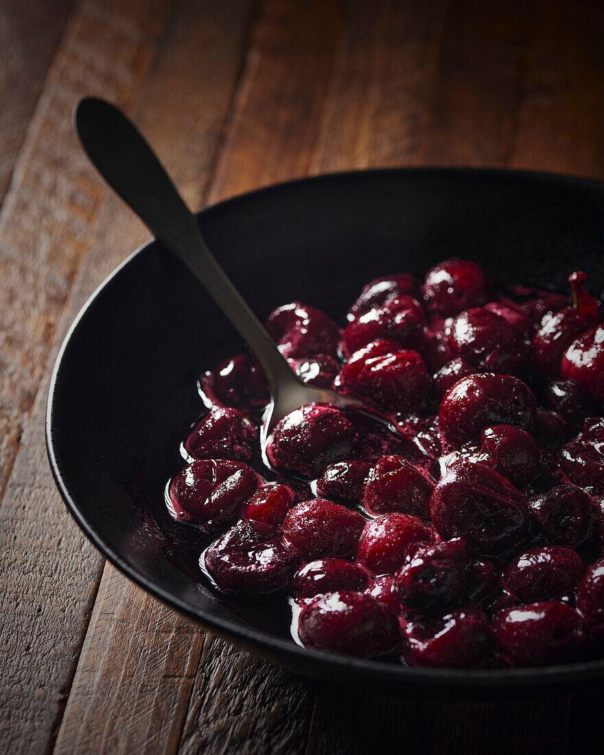 Cherry compote in a black bowl