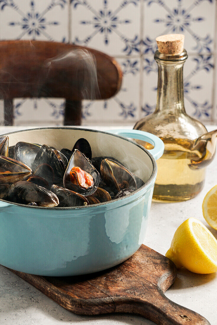 mussels in white wine and lemon juice in a blue cast-iron caseroll