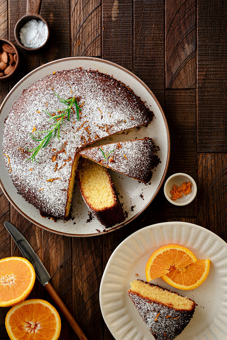 Sliced orange and almond cake on a wooden base