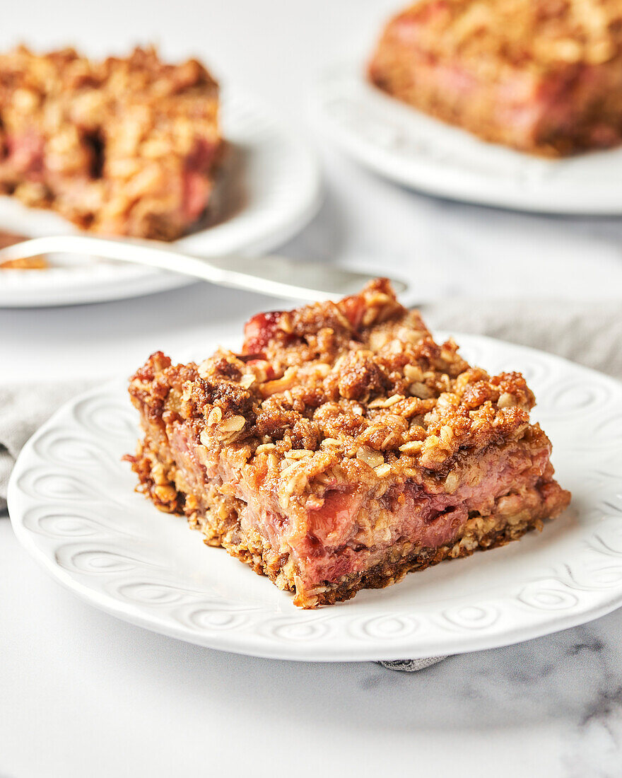 Strawberry and rhubarb crumble cake on a white plate