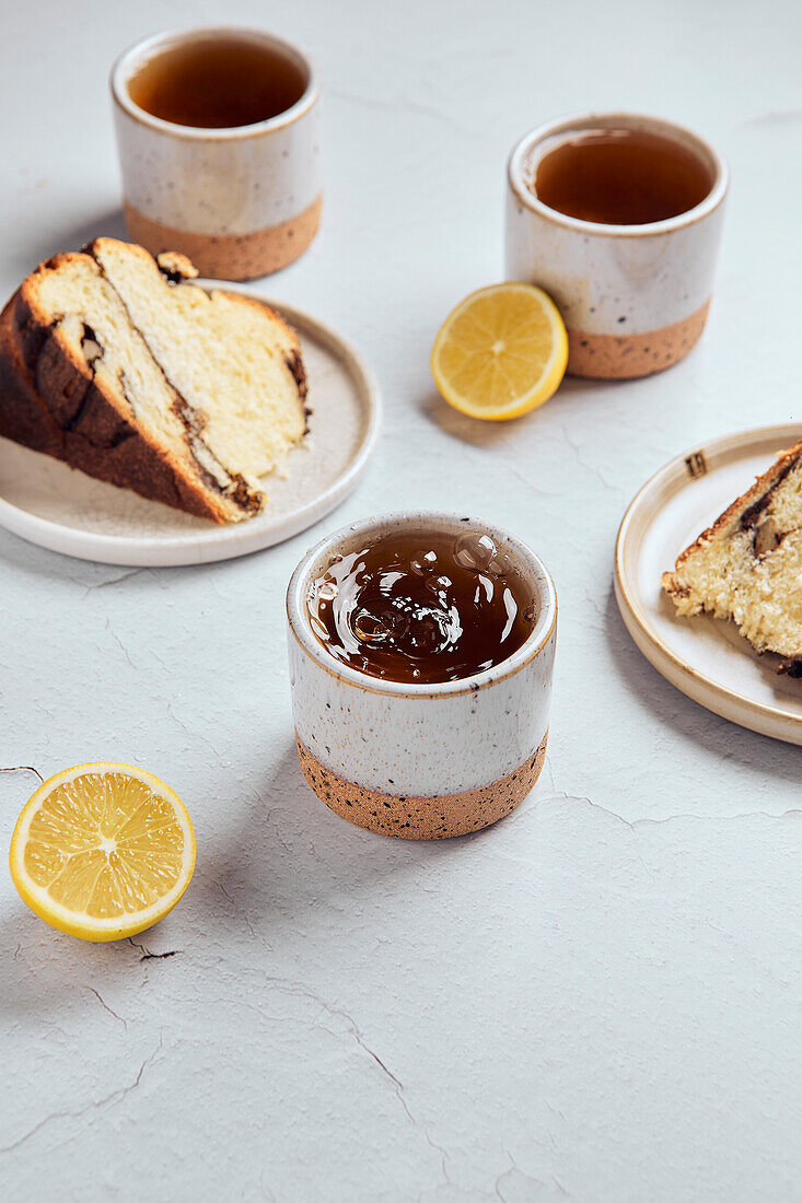 Black tea with lemon in small ceramic mugs