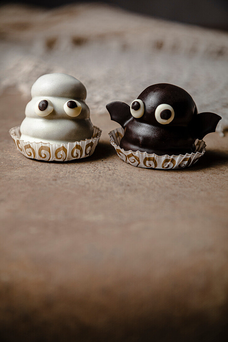 Ghost and bat sweets for Halloween; with biscuit base, dulce de leche filling and chocolate coating.