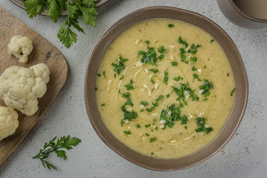 Cream of white vegetable soup. The dish is flavoured with parsley and garlic. View from above