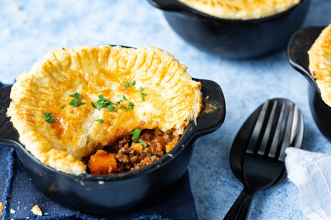 Beef pot pies in a black bowl