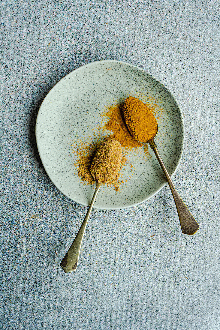 Vintage spoon with powdered spices like ginger and turmeric