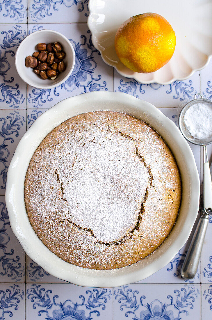 Carrot and hazelnut cake on blue tiles