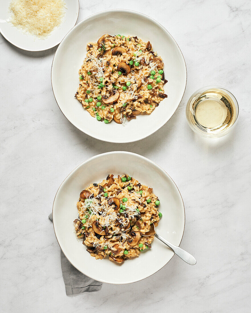 Two bowls of vegan mushroom risotto with peas