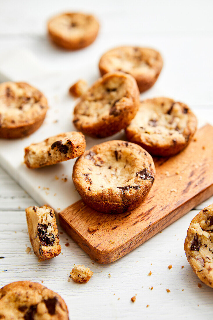 Shortbread biscuits with chocolate chips on a marble board and white background