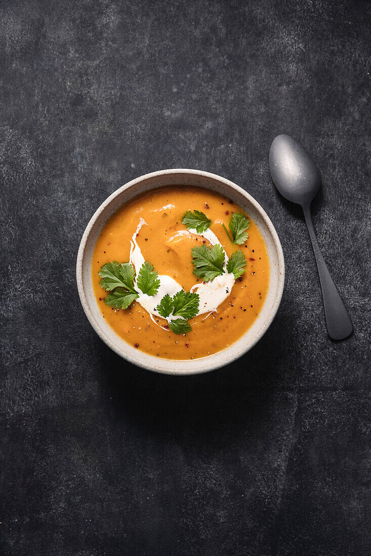 Butternut squash soup with spoon.