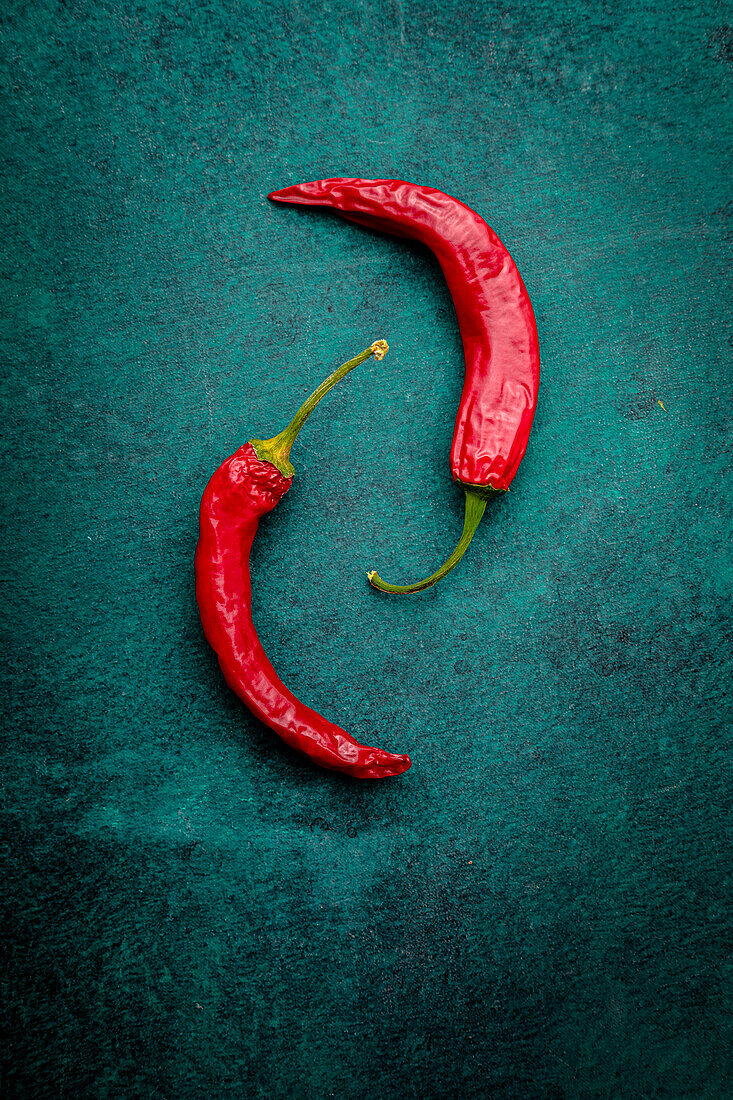Chilli peppers on a green background