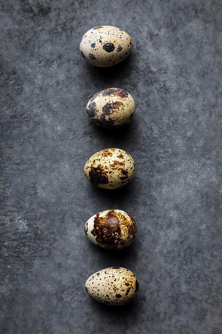 Quail eggs on a dark background