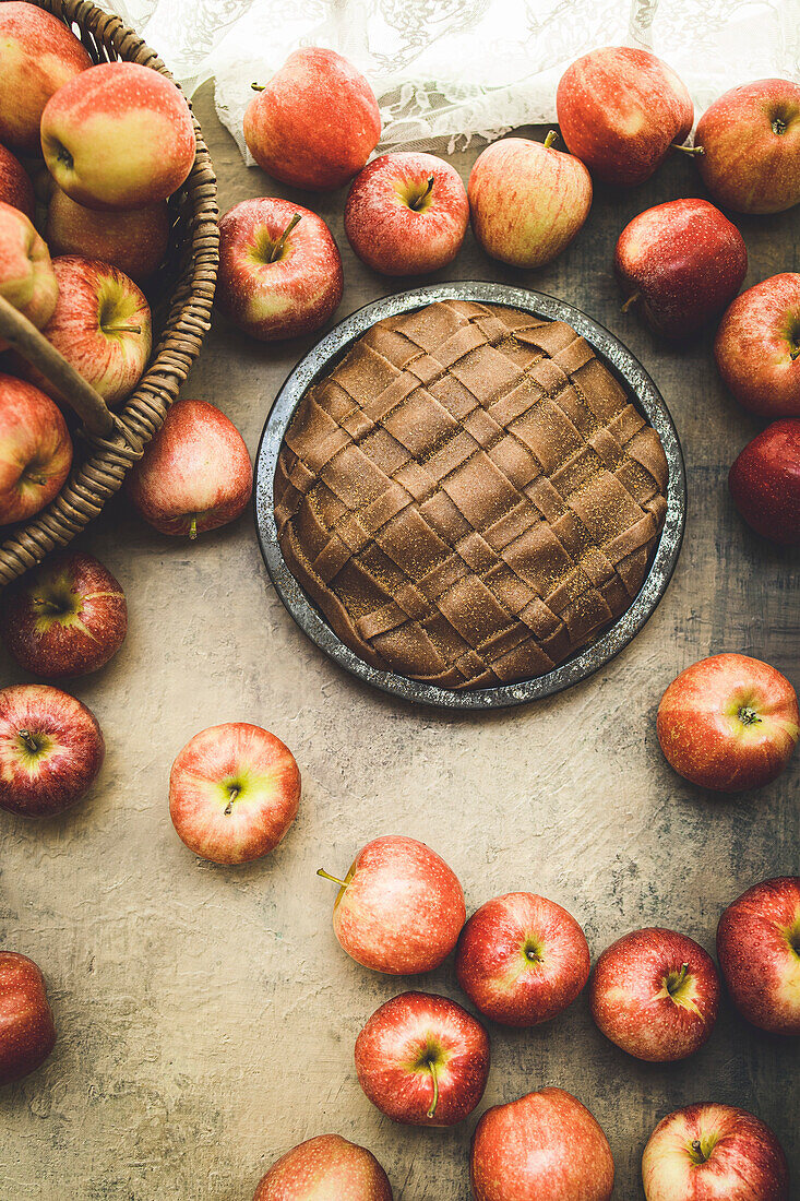 Apple pie and apples in a rustic kitchen
