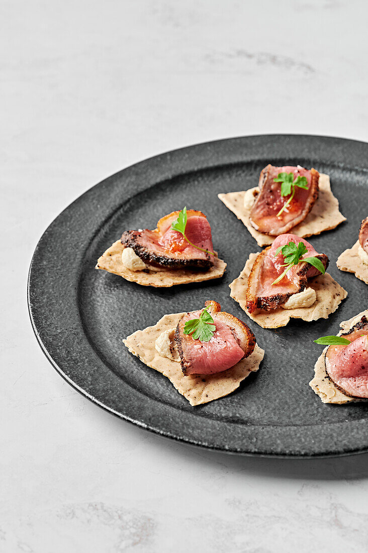 Duck breast, fennel seeds & black pepper crackers, macadamia mousse, orange glaze & chilli salt