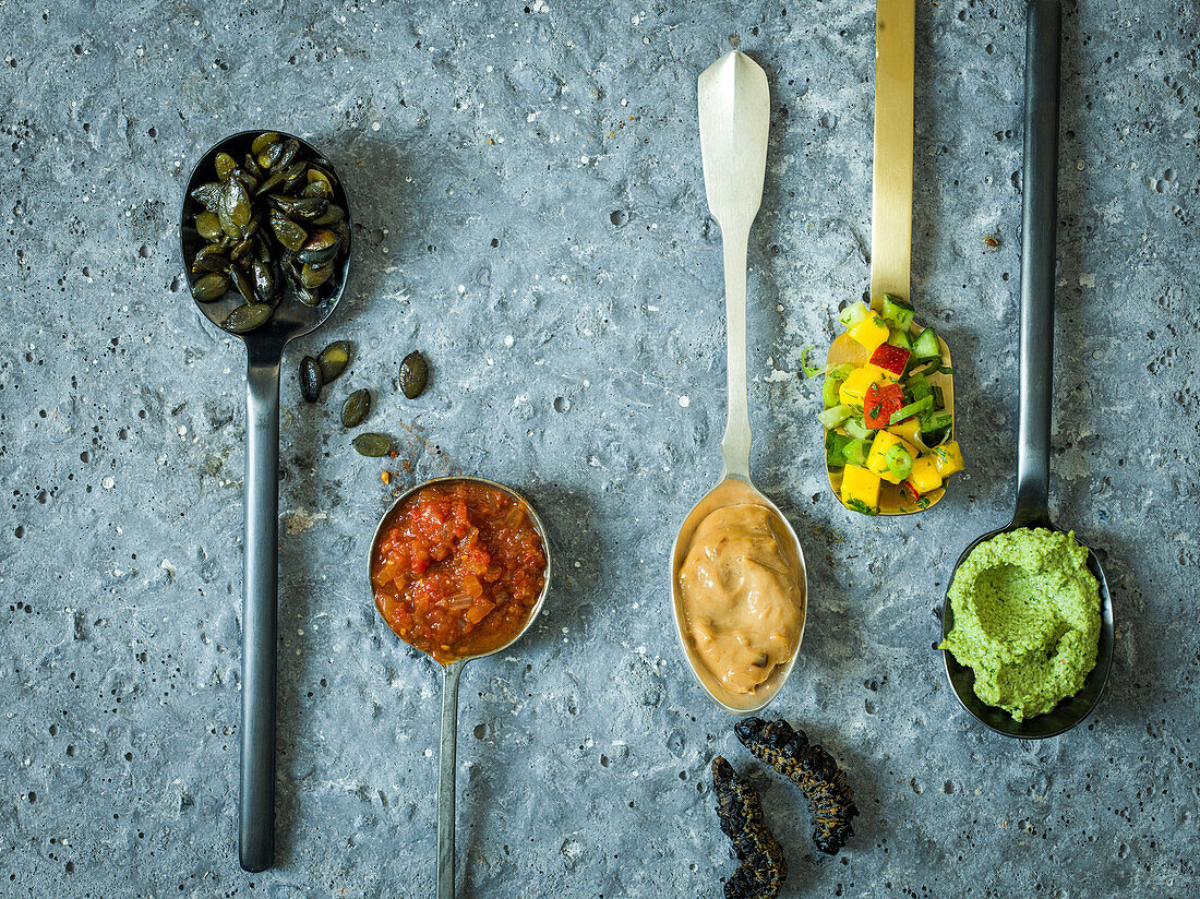 Pumpkin seeds, tomatoes and onions, peanut butter, mopani worms, mango salsa and coriander and cashew paste