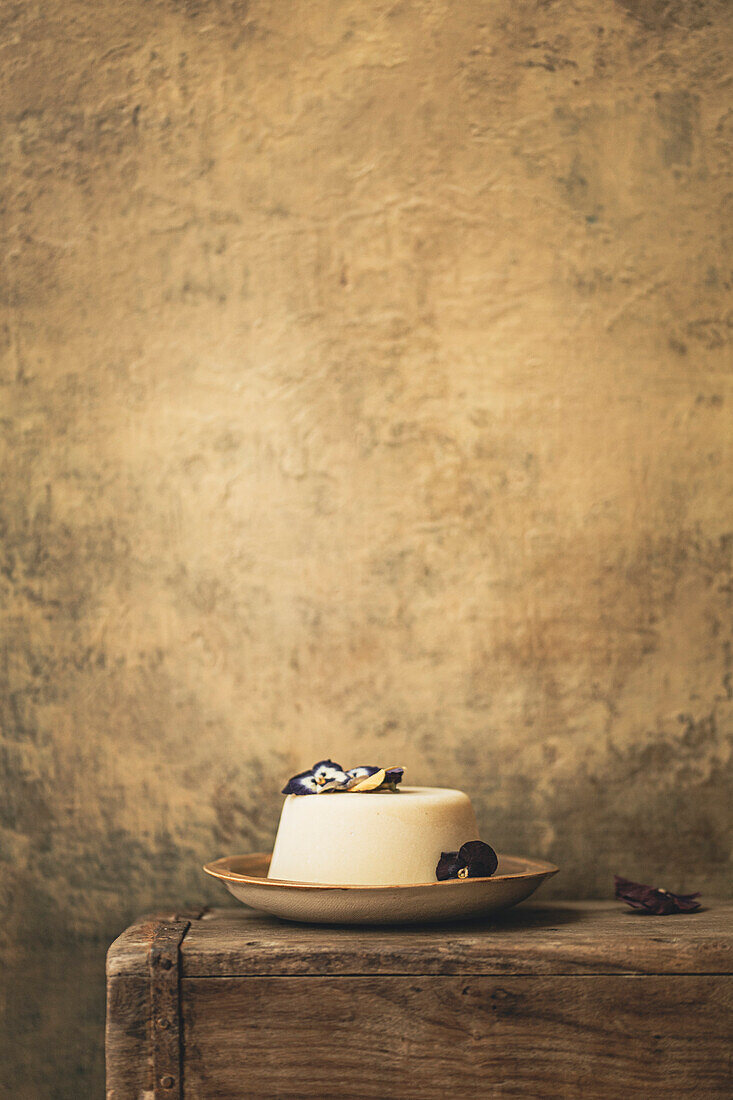 Panna cotta on a plate in a rustic kitchen