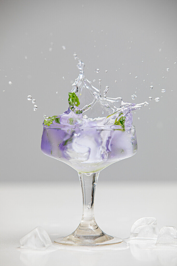 A splash in a cocktail glass with copy space