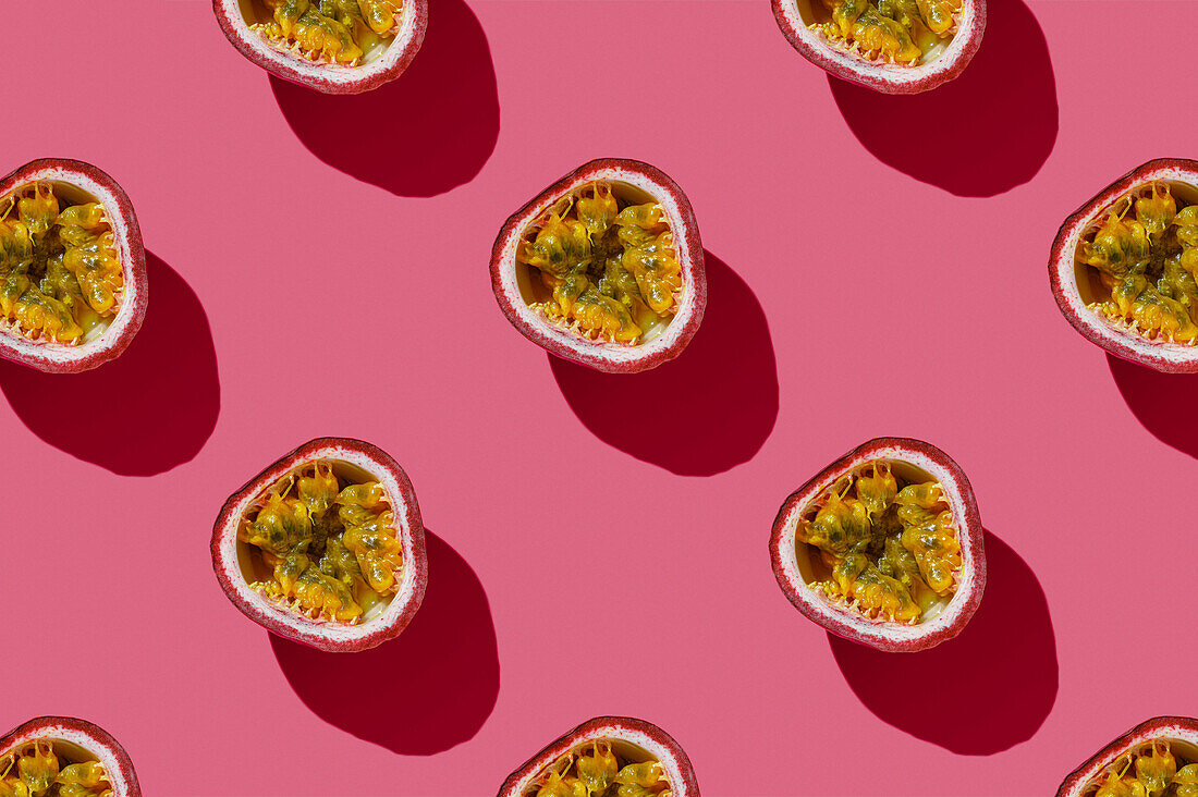 Horizontal Pattern of Tropical exotic Passion Fruit on pink background flatlay food