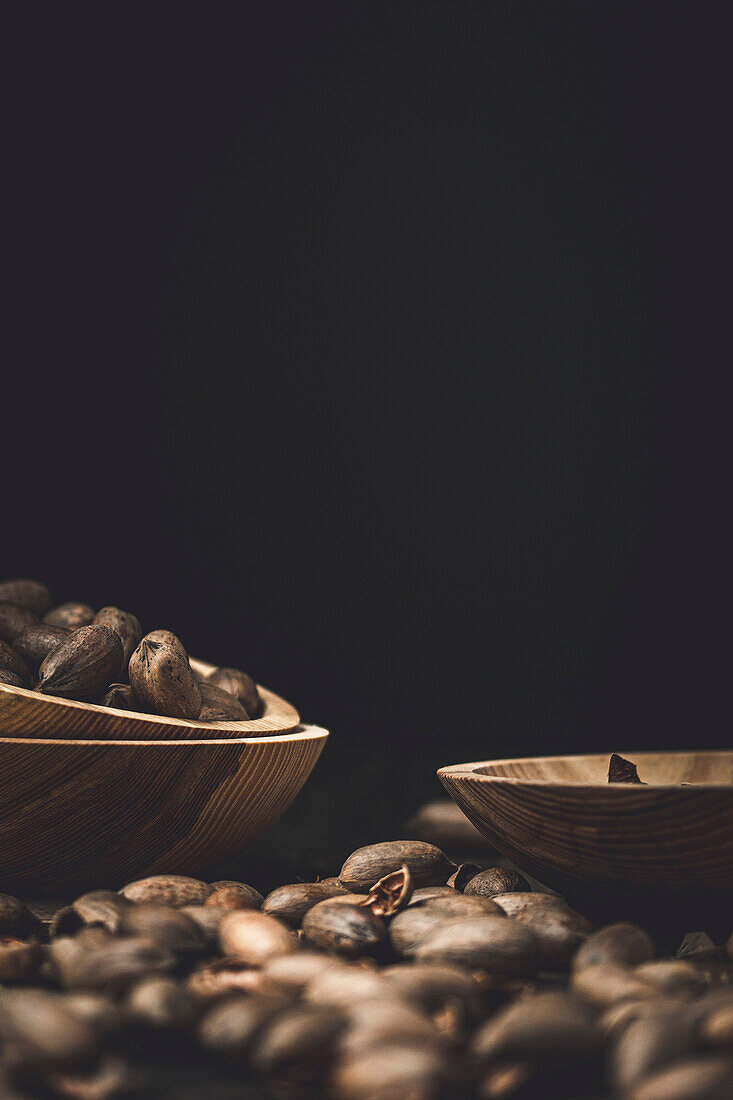 Fresh pecans and broken shells on a rustic wooden background