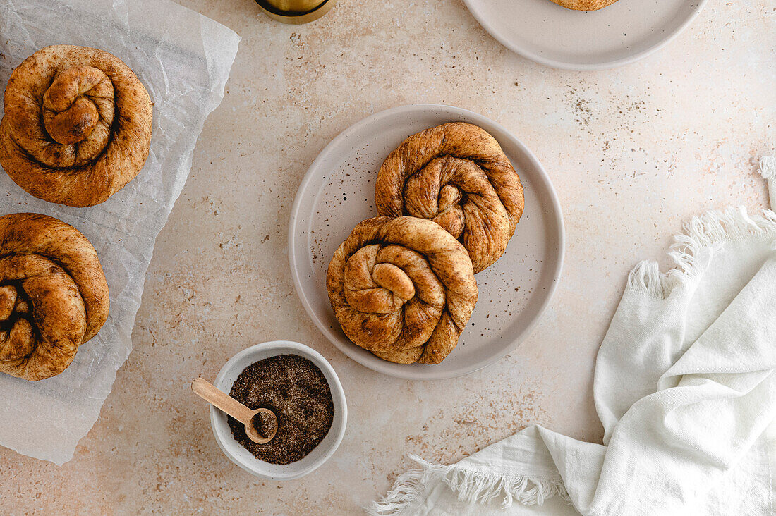 Homemade Dutch cinnamon buns on a plate with brown sugar