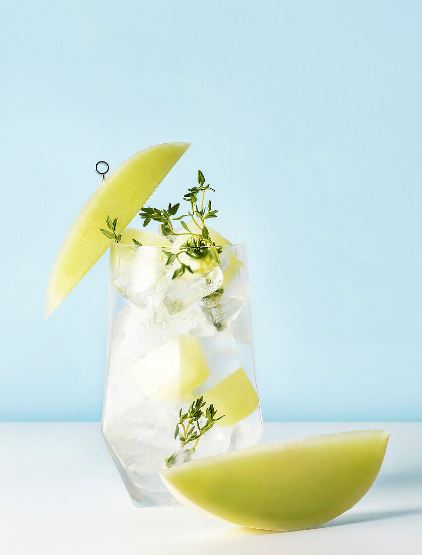 Fresh, refreshing, fruity melon drink in a glass on a blue background