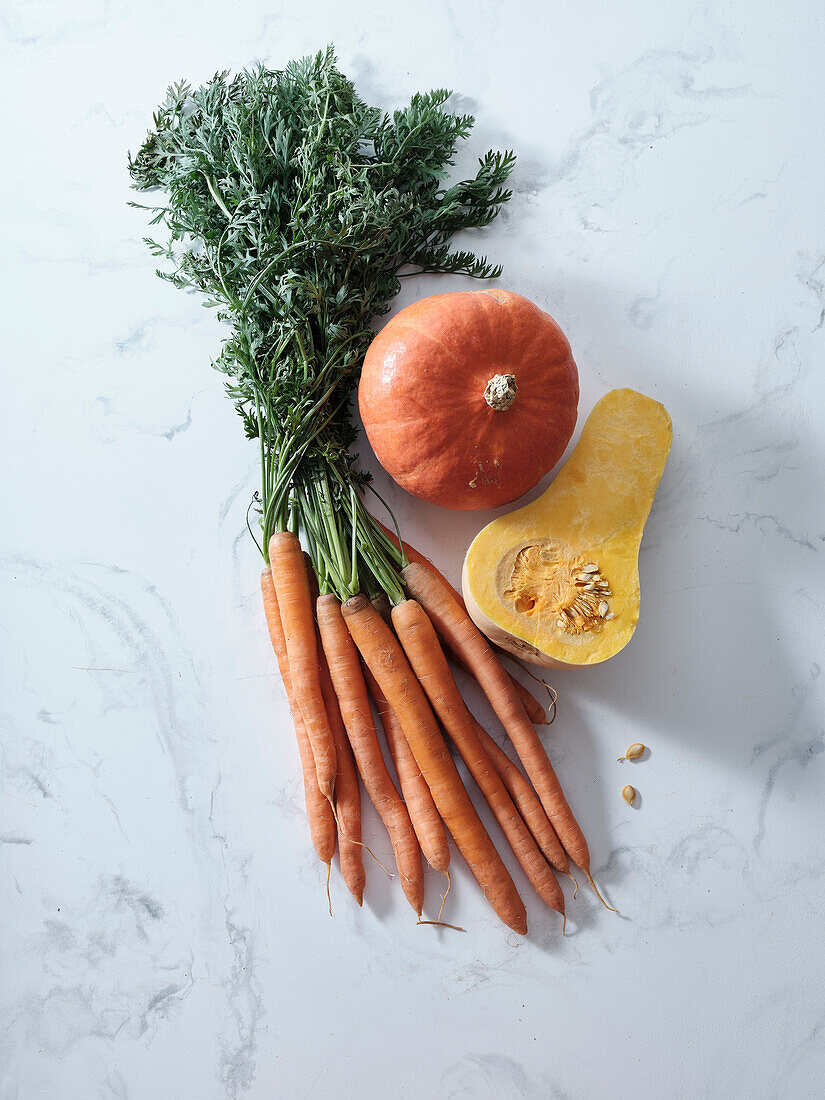 Top view with autumnal orange vegetables. Carrots, pumpkin, butternut squash