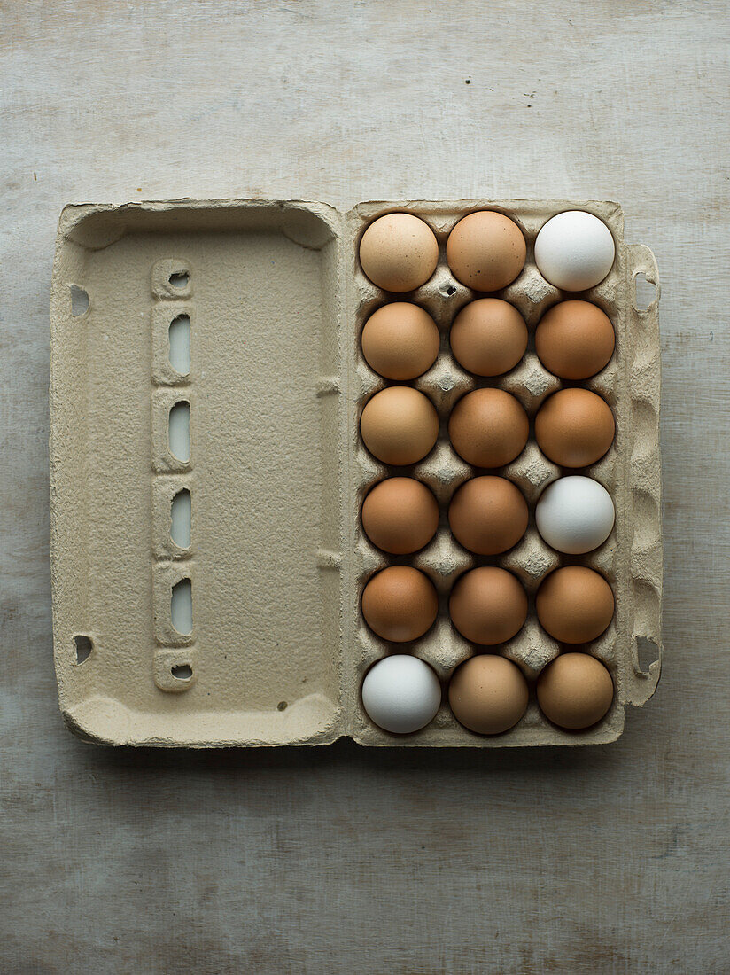 Chicken eggs in a cardboard box with an open lid