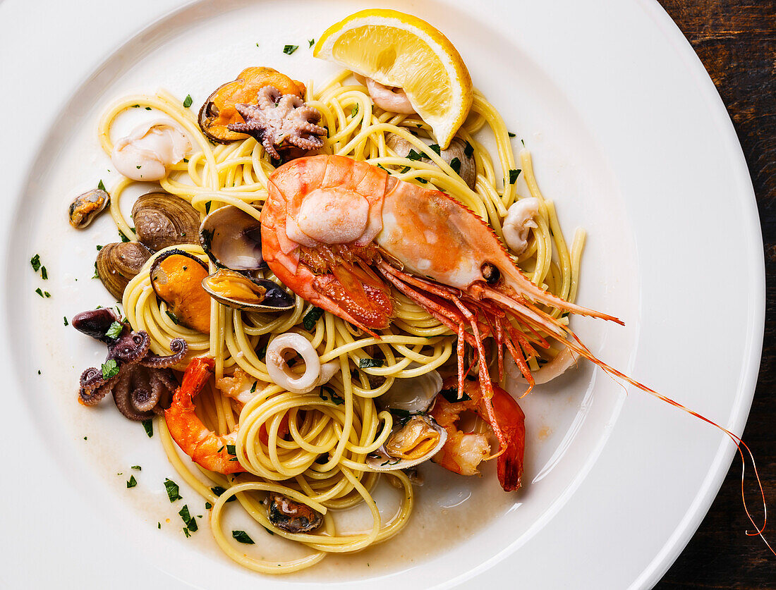 Seafood pasta spaghetti with clams, prawns, seafood cocktail close-up