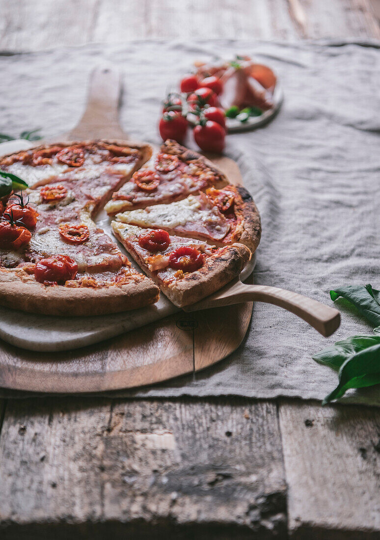 Ham and mozzarella pizza on a cutting board