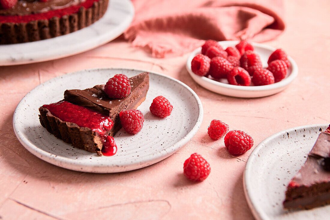 Chocolate and raspberry tart on a pink background