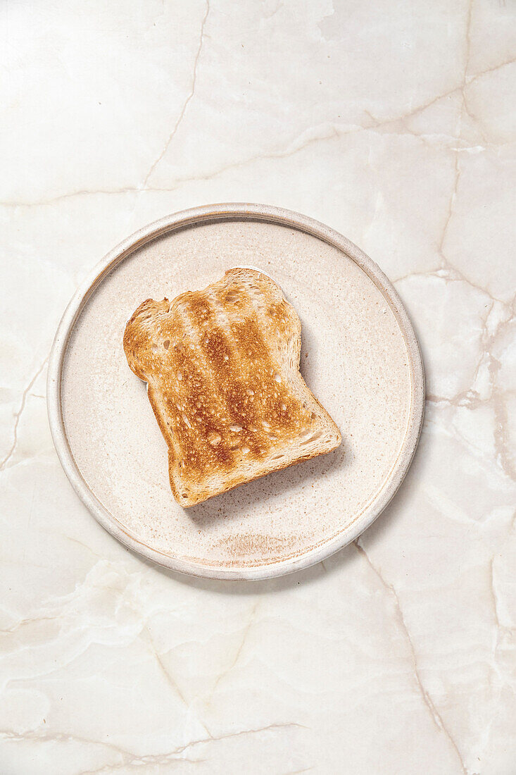Toast on ceramic plate on a marble background