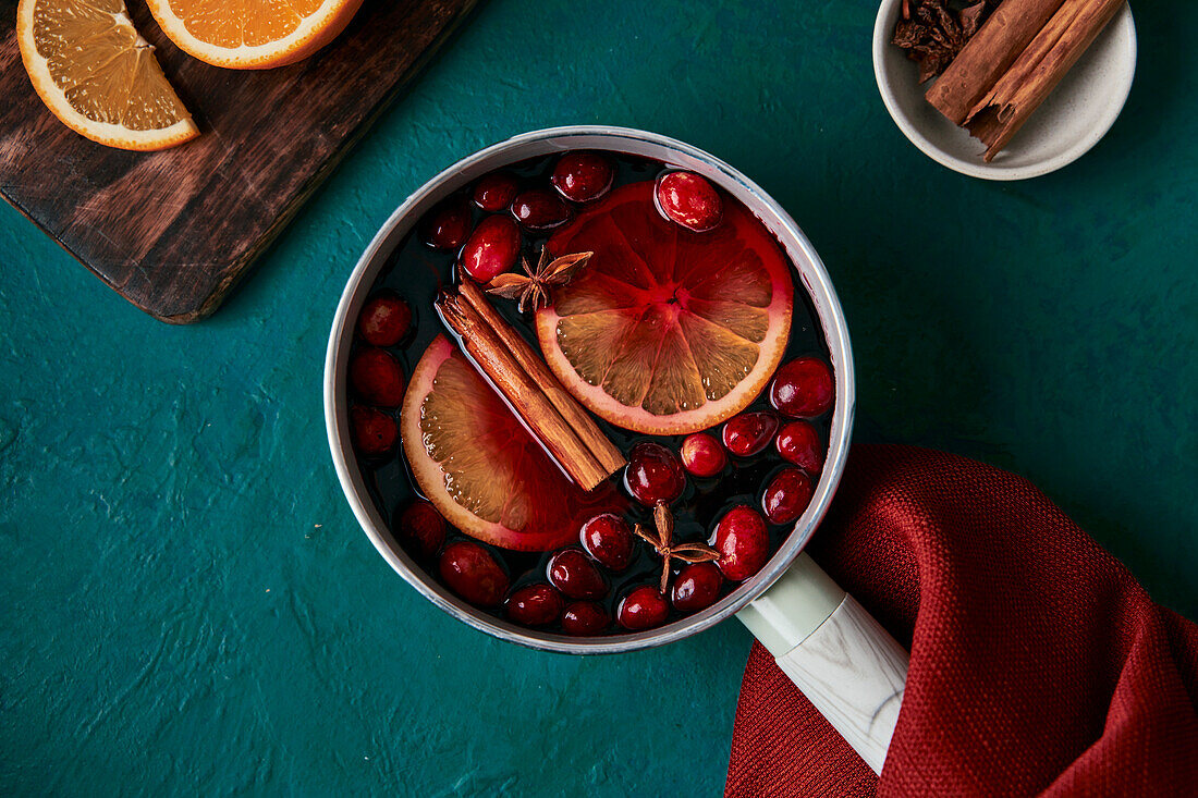 Mulled wine preparation with orange cranberries and cinnamon