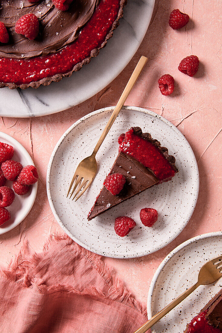 Chocolate raspberry cake on a pink background