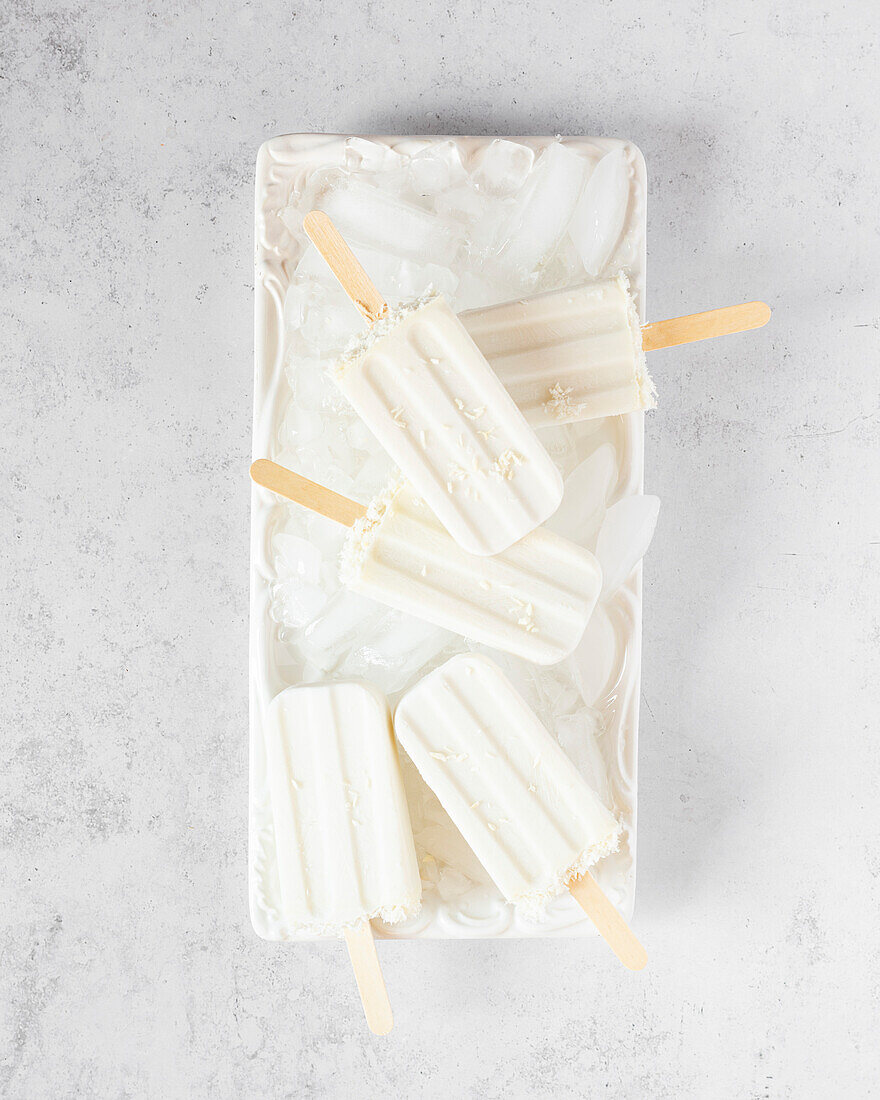 Coconut Popsicles on White Plate with Ice