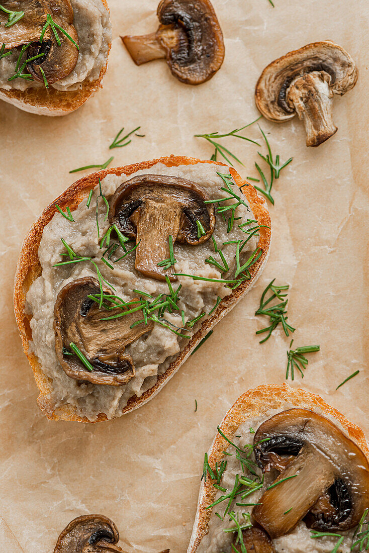 Sandwiches with mushroom pate and mushrooms on kraft paper.
