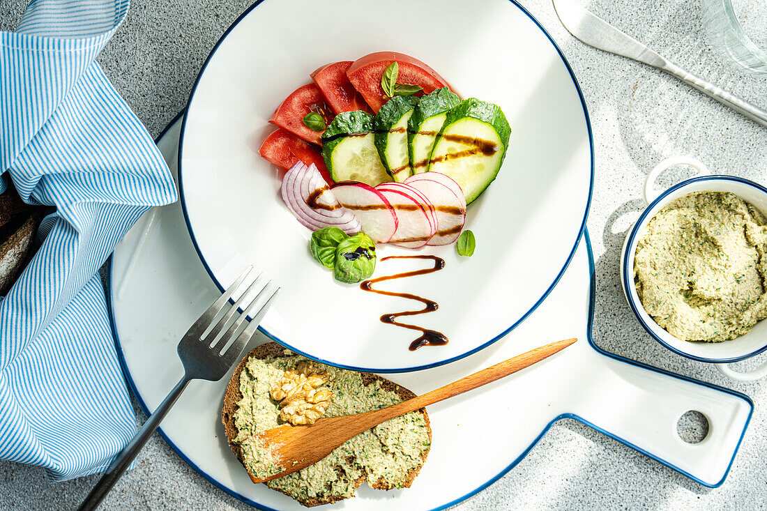 Healthy lunch from above with vegetable salad and toasts with walnut paste